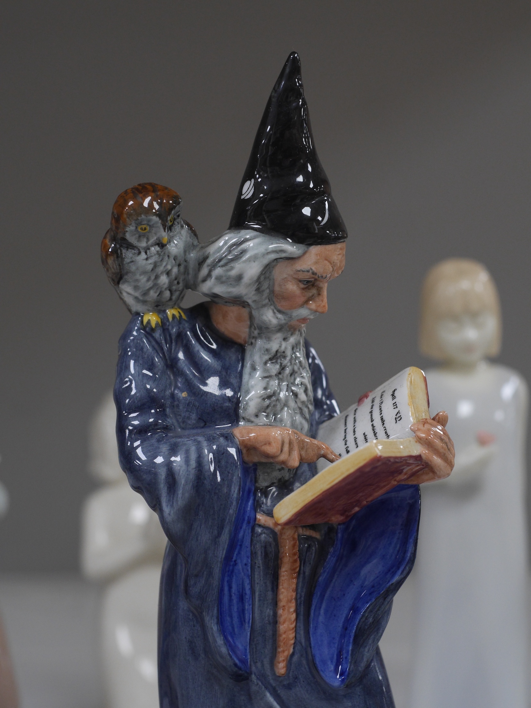 A Royal Doulton figure ‘The Wizard’ HN 2877, together with a quantity of Nao figures, Royal Worcester and Hummel figures, The Wizard 25cm high. Condition - Hummel figure chip to hat, NAO figure with candle holder, opposi